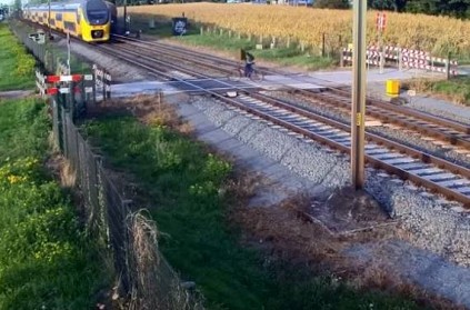 Cyclist almost gets hit by train - Misses by an inch